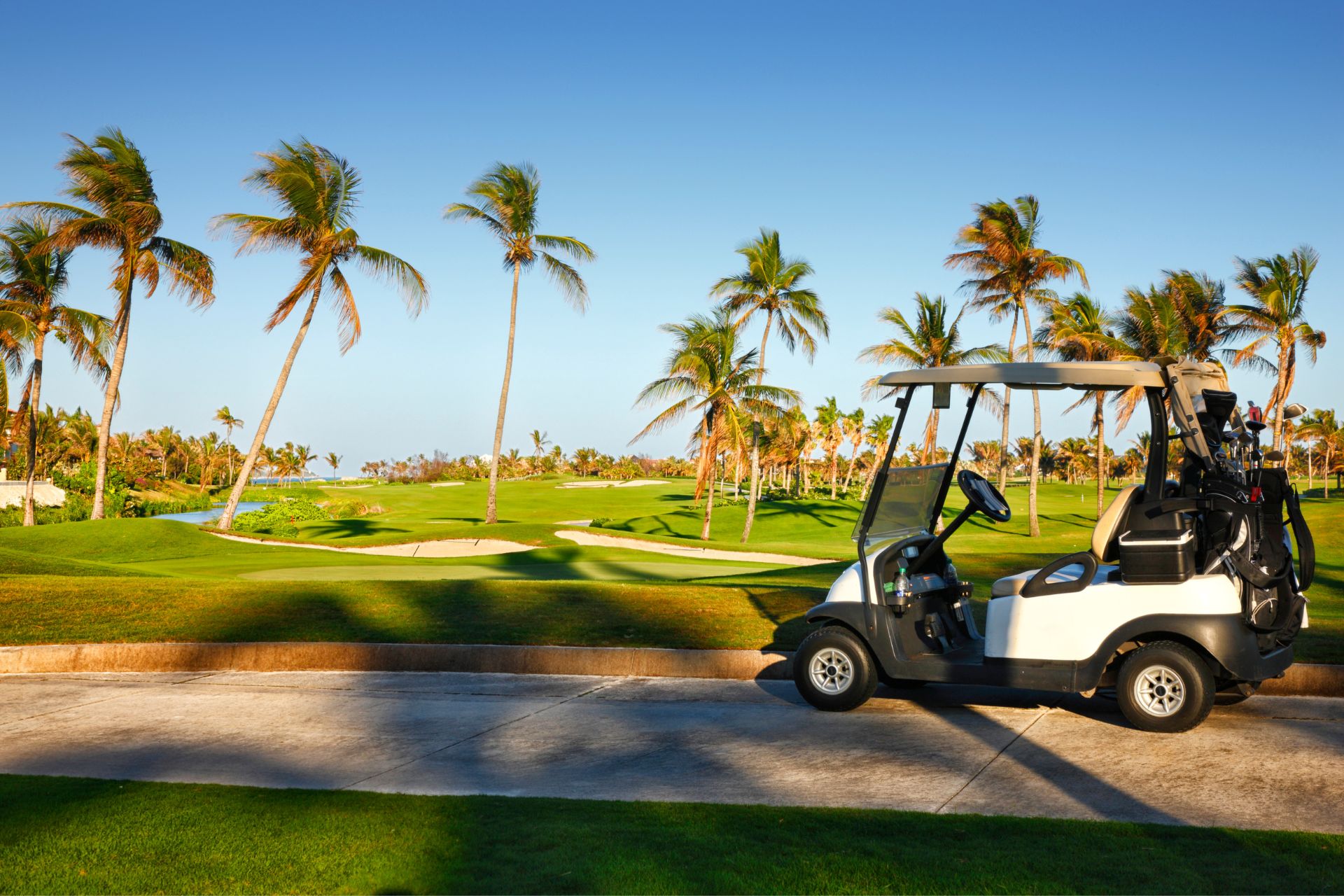 A golf cart on one of the best golf courses in Orlando, surrounded by fairways and scenic views.